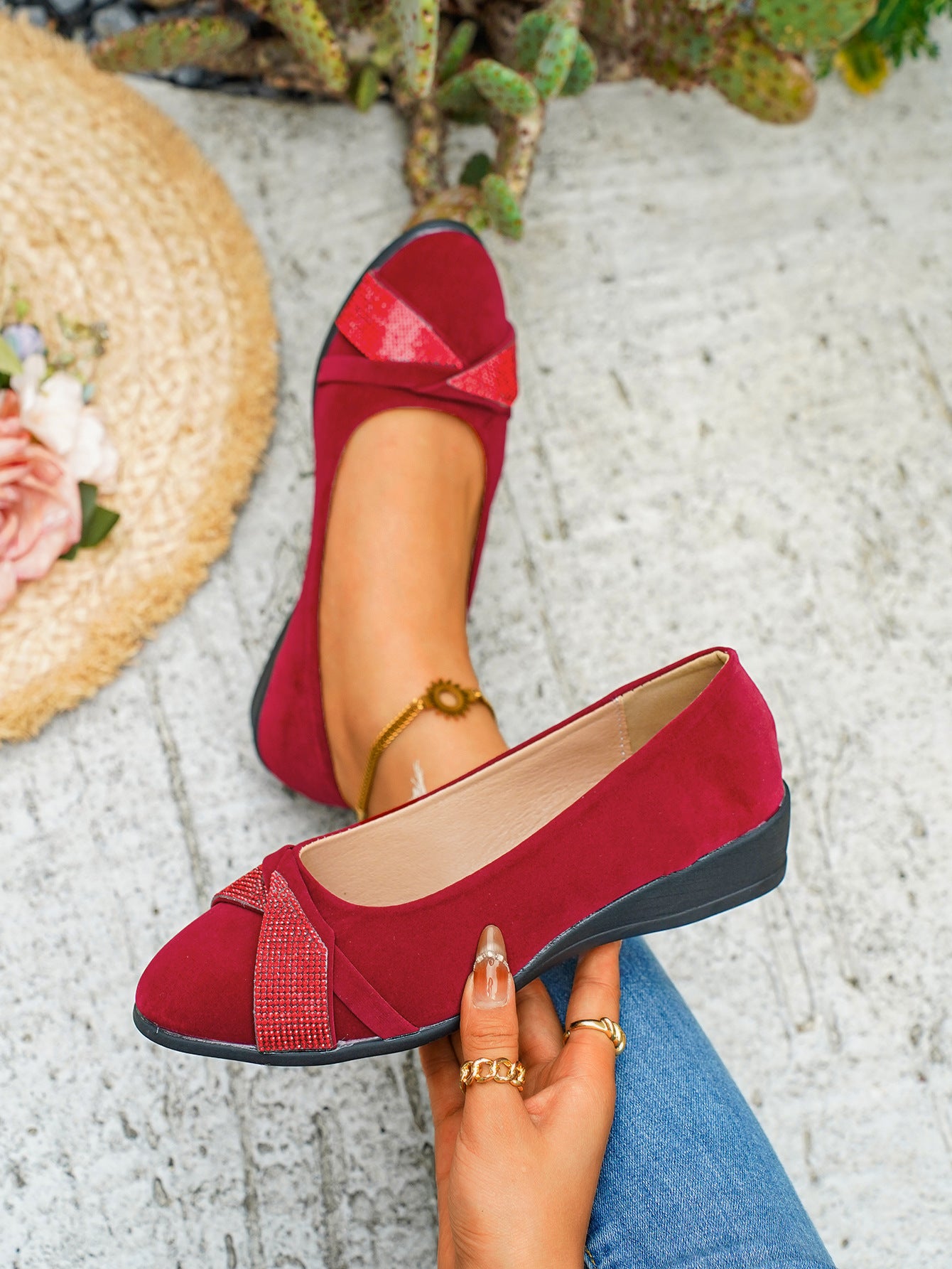 Red slip-on wedge flats with rhinestone adorned criss-cross detail
