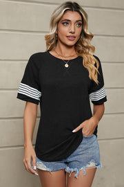 Black raglan sleeve tee with white varsity stripes on sleeves and X detail at neckline