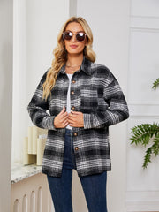 Black plaid shacket with oversized button detail and chest pockets.