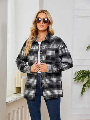 Black plaid shacket with oversized button detail and chest pockets.