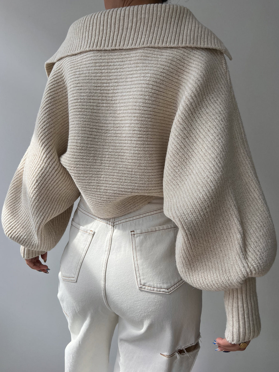 Cream knit sweater with wide collar and balloon sleeves, shown from the back.