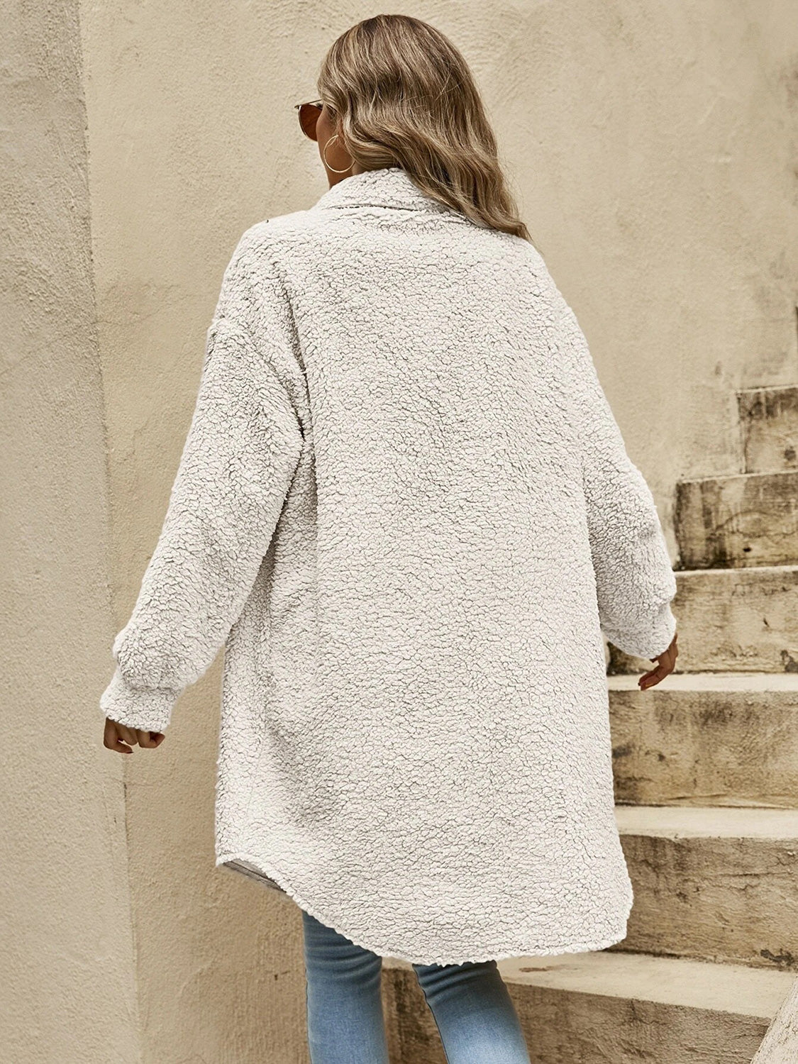 Oversized white teddy bear shacket with button-down front and long sleeves.