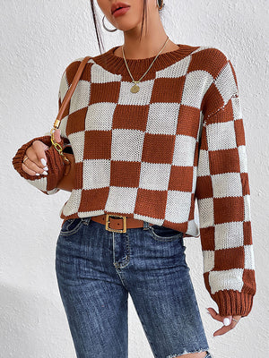 Checkerboard knit crewneck pullover sweater in chestnut and white acrylic with long sleeves.