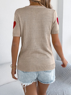 Tan knit t-shirt with red heart details on sleeves.
