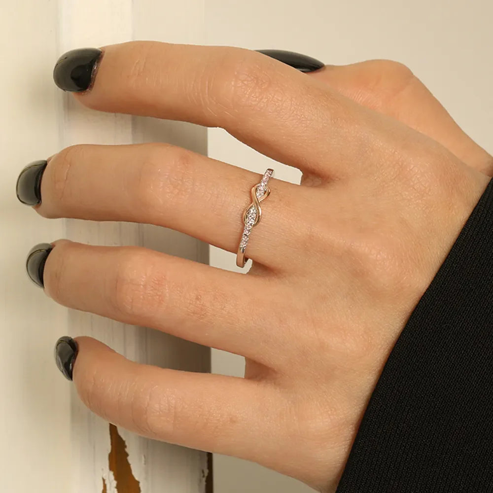 Infinity knot ring with diamonds in blush pink and silver tones
