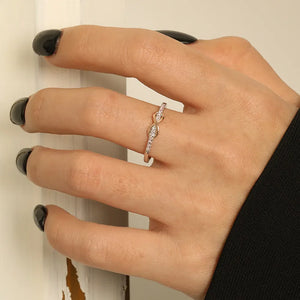 Infinity knot ring with diamonds in blush pink and silver tones