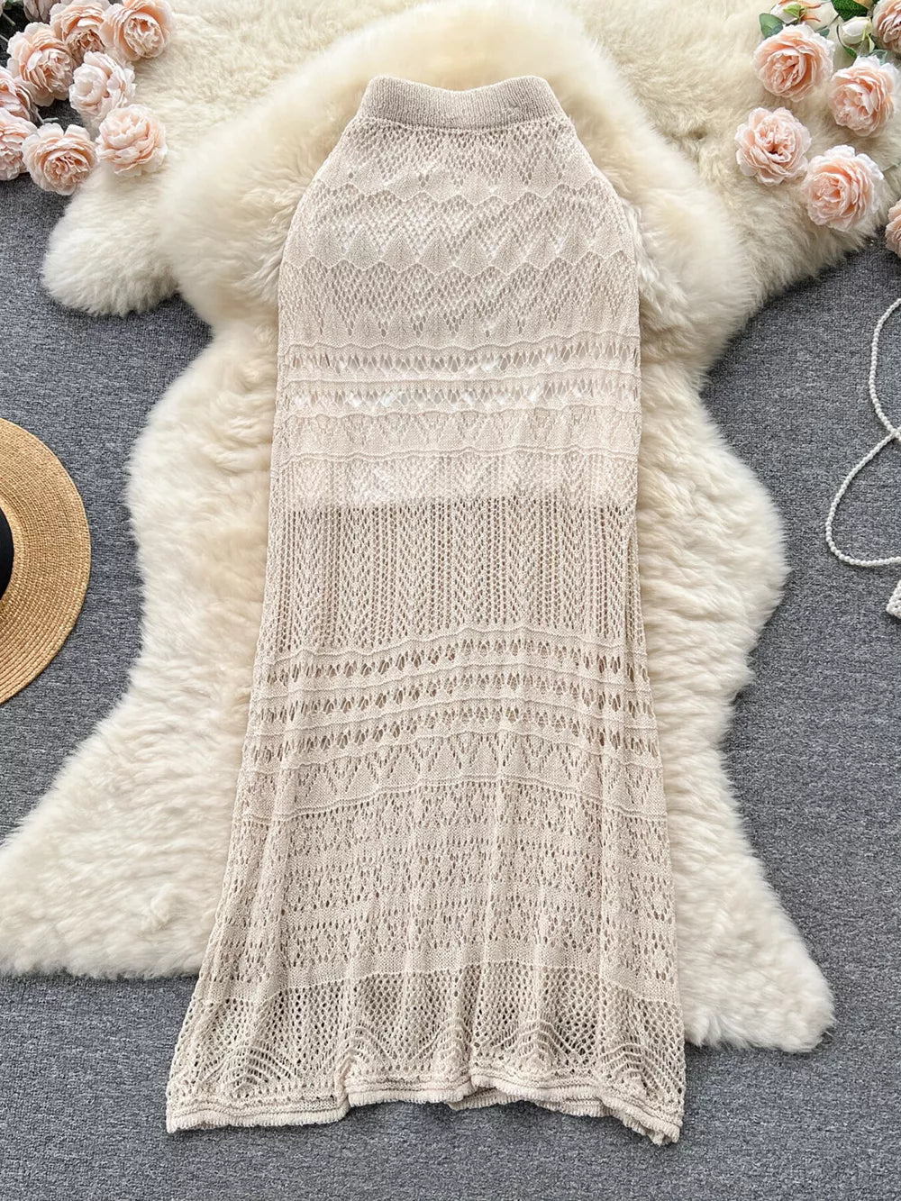 Apricot knit maxi skirt with intricate openwork patterns and a high neckline.