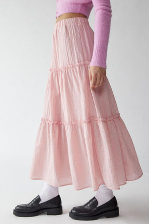 Tiered cotton maxi skirt in blush pink with ruffled tiers and an elastic waist.