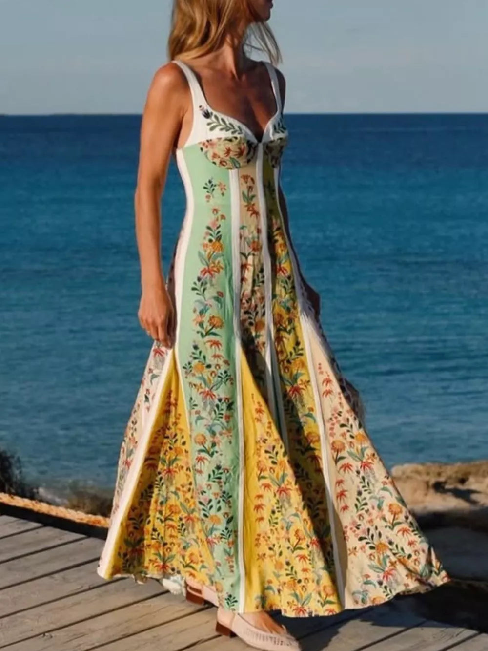 Botanical print sweetheart maxi dress with a sweetheart neckline and a flowing skirt.