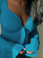Blue long sleeve t-shirt with tie-front detail and deep V-neckline.