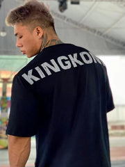Black oversized t-shirt with white KINGKONG graphic on back.