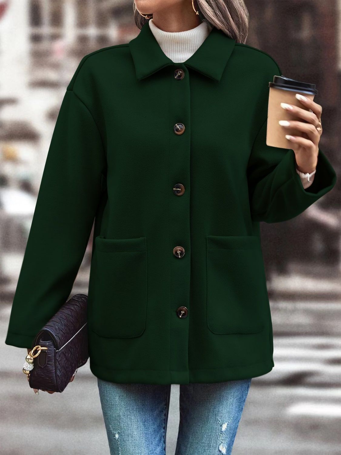 Oversized green shirt jacket with flap pockets and button front, styled casually.
