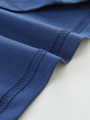 Blue cotton t-shirt detail showing hem stitching and fabric texture