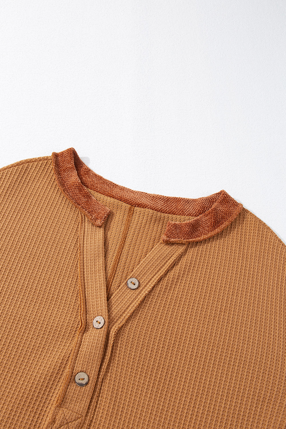 Caramel waffle knit henley top with contrast stitching and button placket.