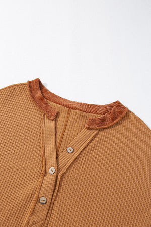Caramel waffle knit henley top with contrast stitching and button placket.