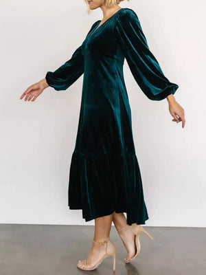 Peacock blue velvet midi dress with tiered skirt and balloon sleeves.