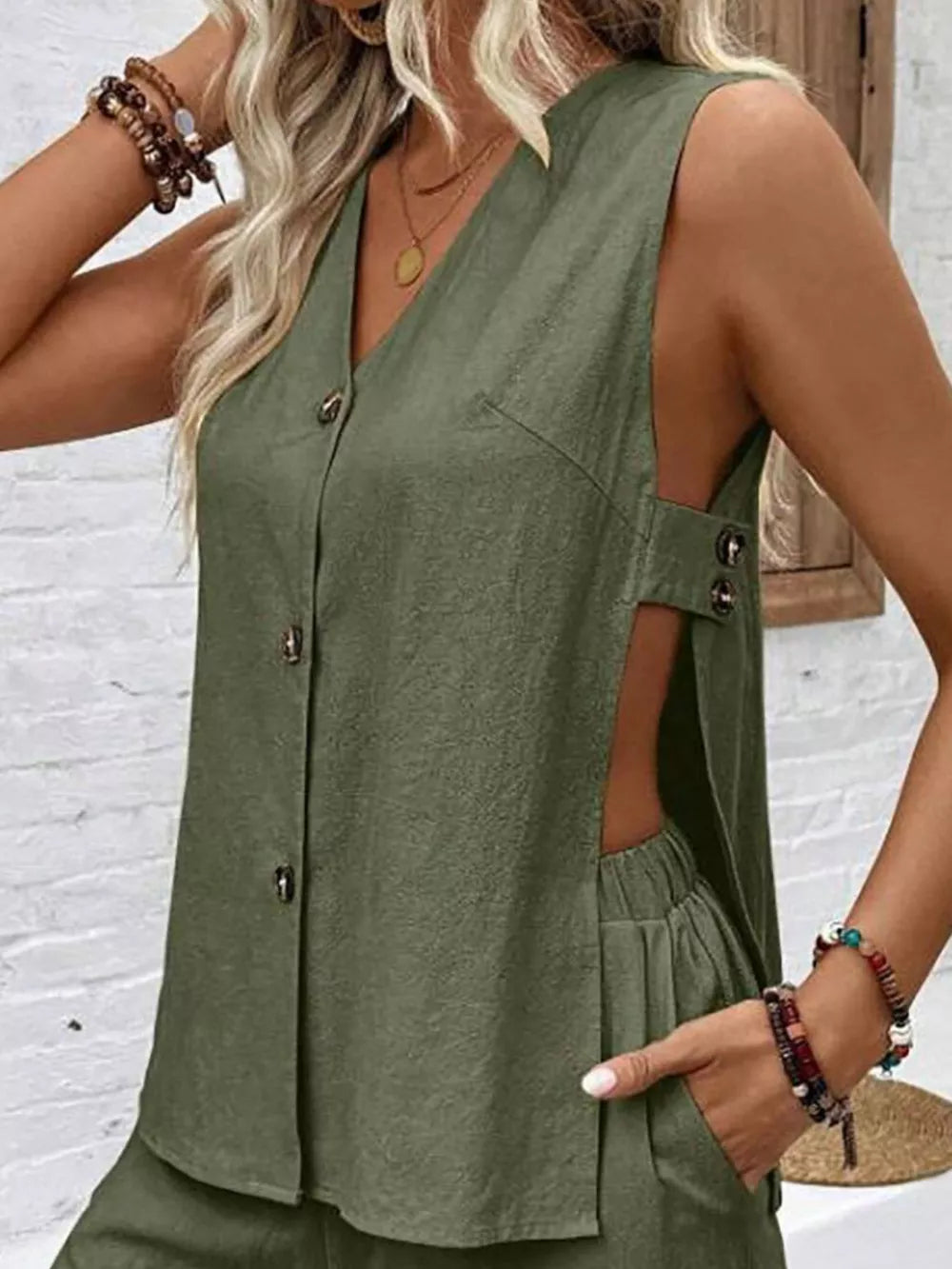 Army green V-neck sleeveless button-front top with side cutouts and matching shorts.