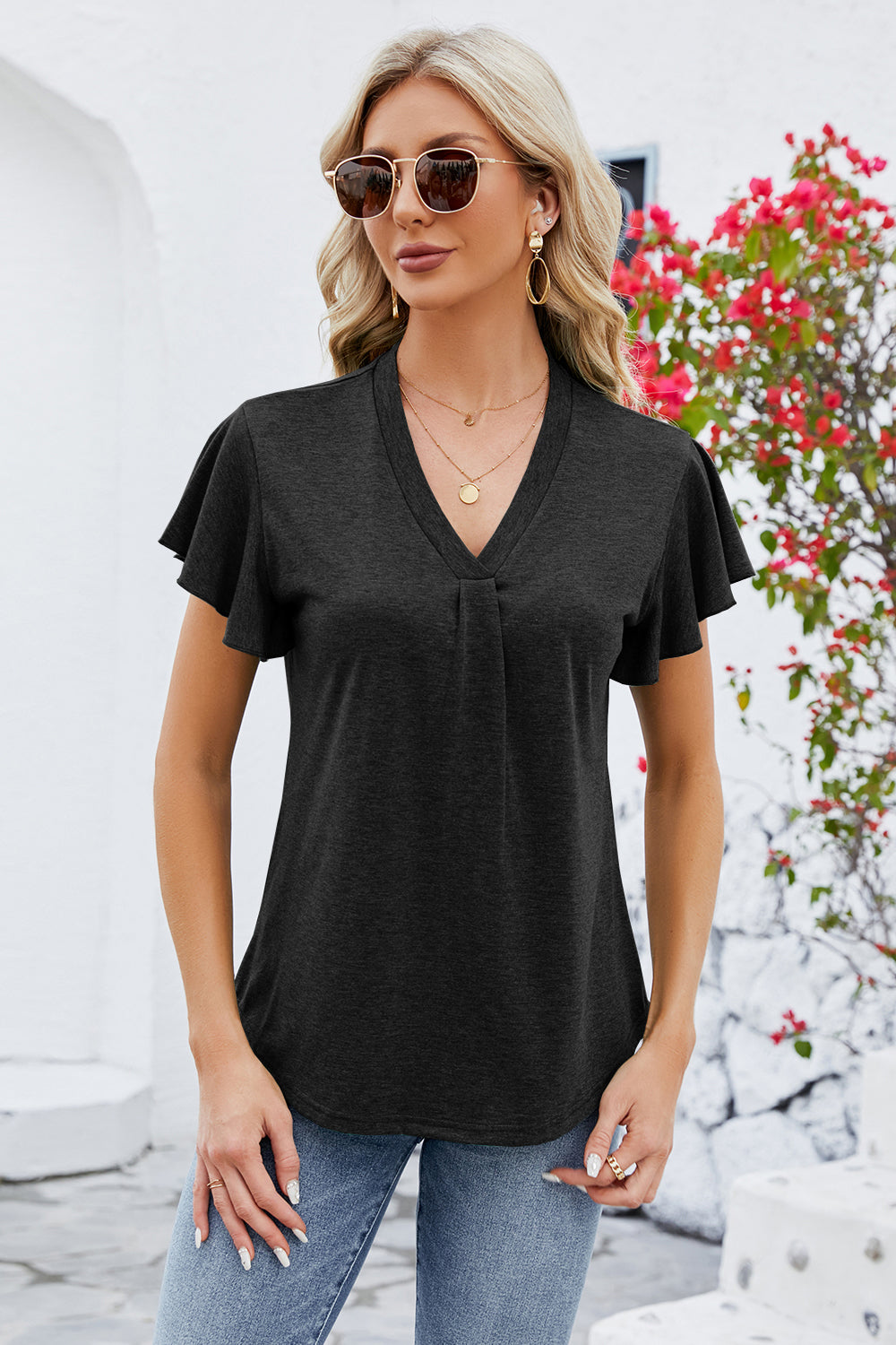 Black V-neck pleated flutter sleeve blouse with a casual fit.
