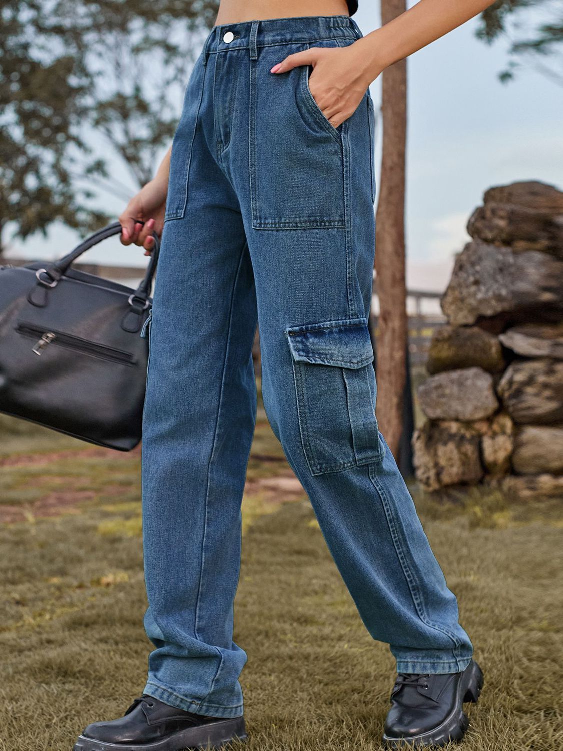 Medium wash denim straight leg cargo pants with multiple pockets.