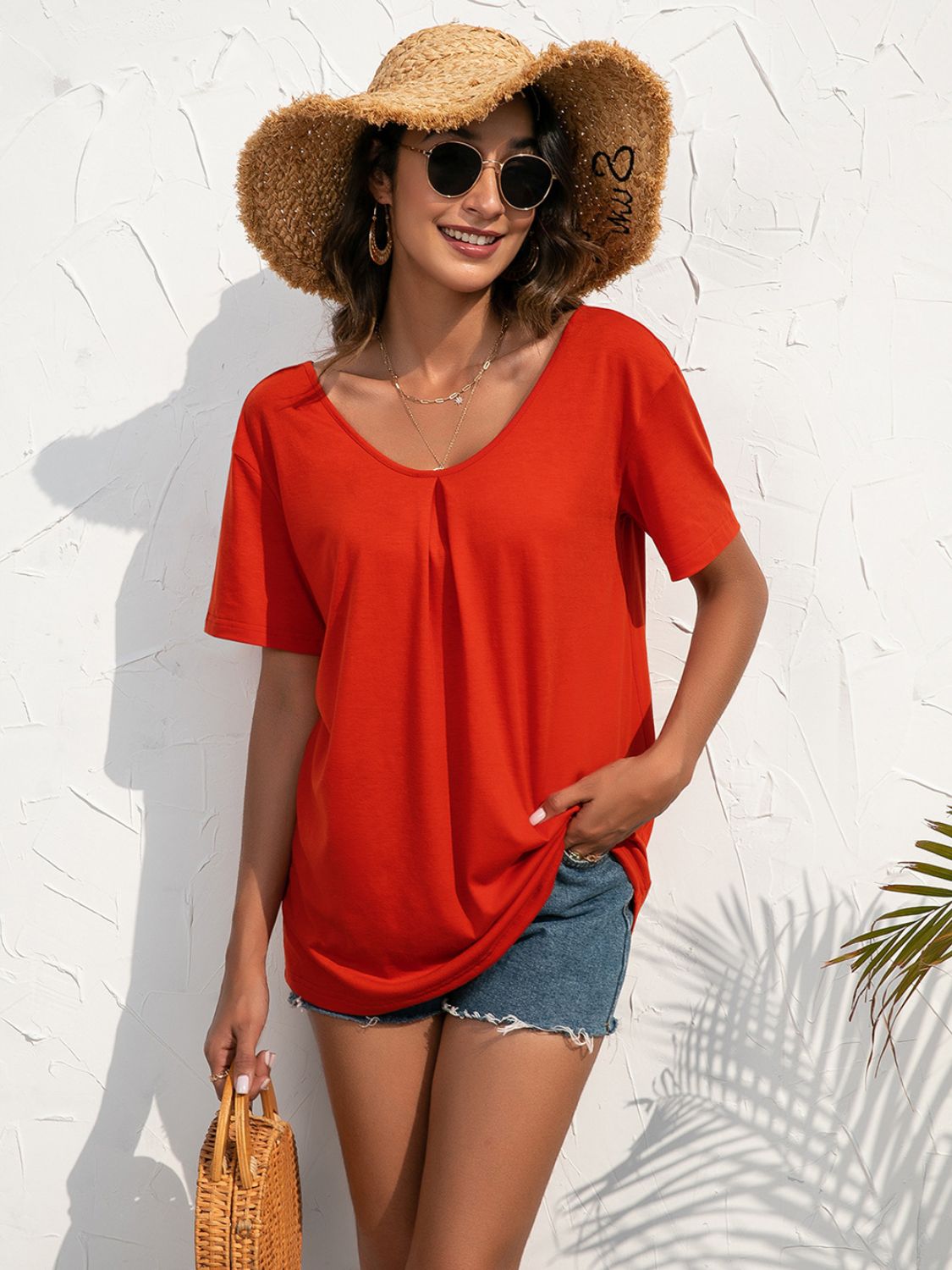 Red orange t-shirt with v-neck and subtle front pleats, short sleeves, casual style