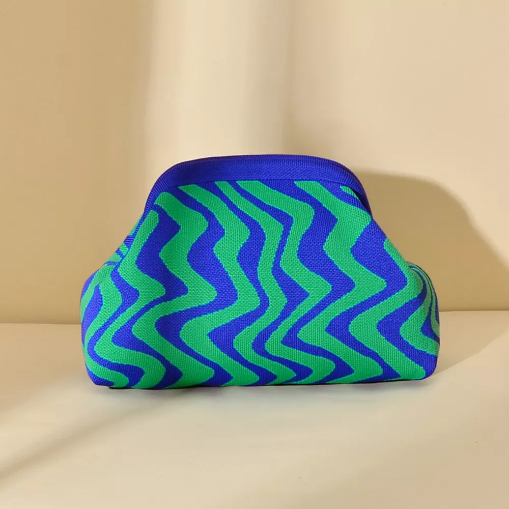 Vibrant knit clutch with striking blue and green wavy stripes.