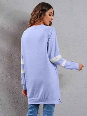 Varsity stripe raglan sweatshirt dress in blue purple with white stripes on sleeves.