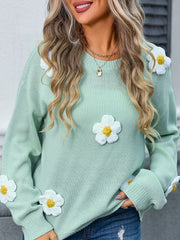 Mint green acrylic knit sweater with white daisy appliqués and balloon sleeves.