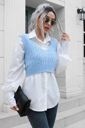 Light blue cropped cable knit v-neck vest over a white button-down shirt.