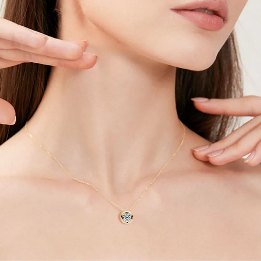 Gold solitaire pendant necklace with bezel-set diamond on a delicate chain