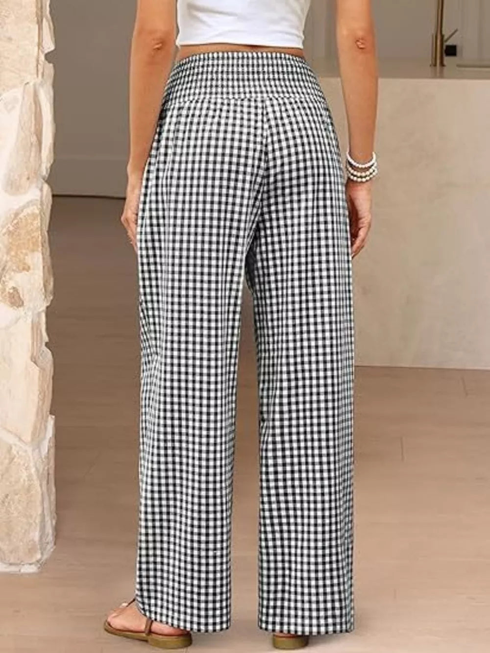 Maternity pants in black plaid gingham with a smocked waistband and wide legs.