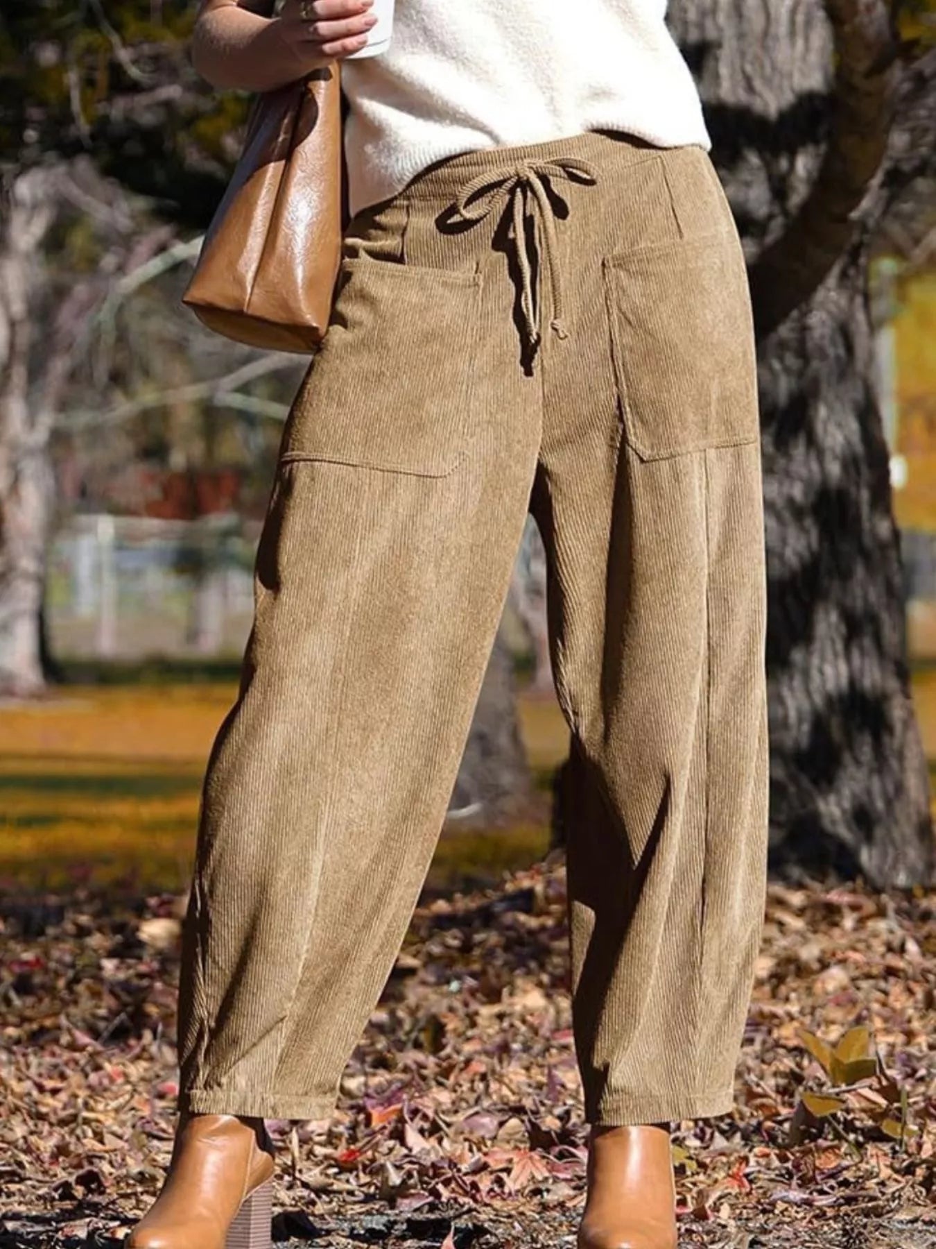 Brown corduroy wide-leg pants with drawstring waist and pockets.