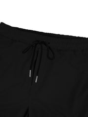 Black textured waffle knit joggers with drawstring waist and metal-tipped drawcords.