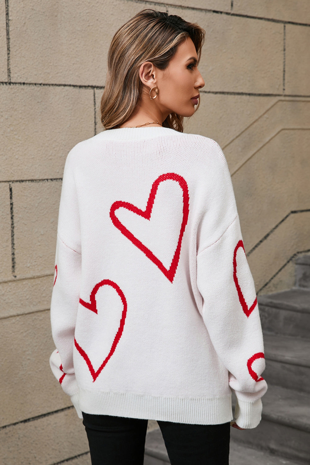 White acrylic knit jumper with red heart outline pattern, crew neck, long sleeves.