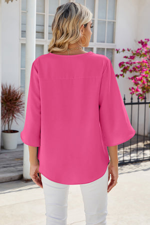 Hot pink flow blouse with asymmetric bell sleeves and a casual cut.