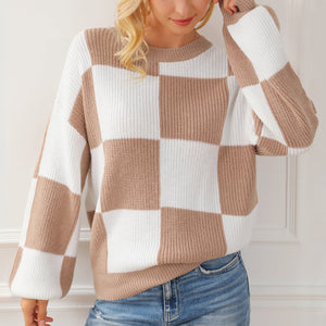 Checkerboard knit drop shoulder pullover sweater in tan and white acrylic with crew neck and balloon sleeves.