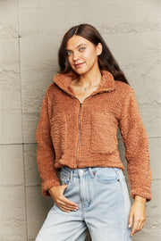 Caramel teddy fleece cropped jacket with a zip-up collar and pockets.