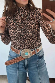 Leopard print high neck slim shirt with long sleeves, styled with jeans and a western belt.
