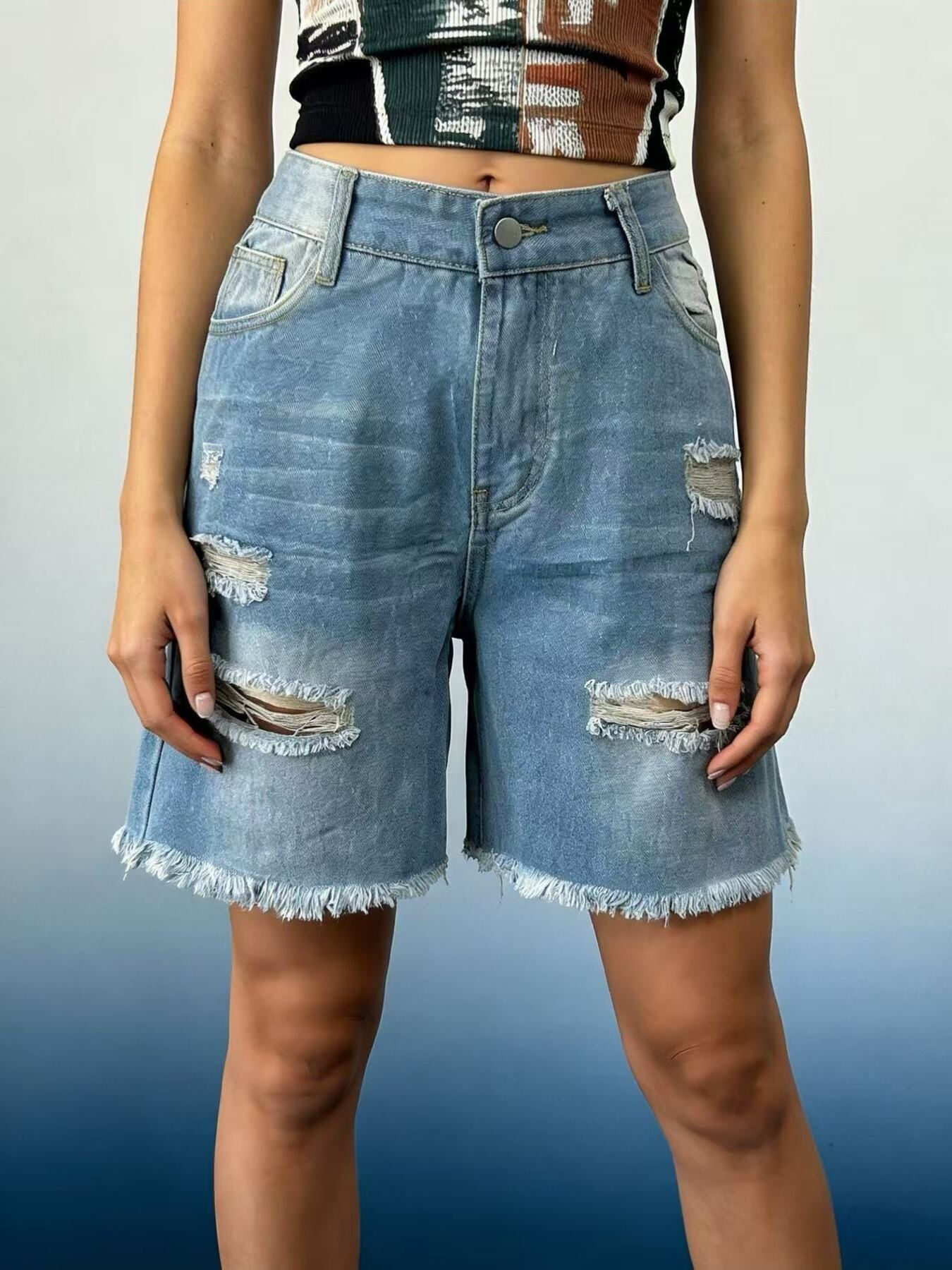 Light blue distressed denim shorts with frayed hem and ripped details.