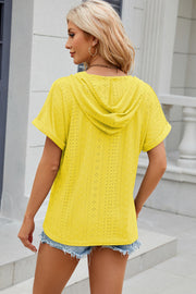 Yellow perforated henley hooded tee with short sleeves and cuffed hems.