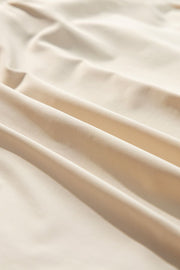 Beige ruffled skort with tie waist detail, close-up fabric texture.