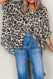 Leopard print oversized button-down blouse with ruffled sleeves, styled with jeans.