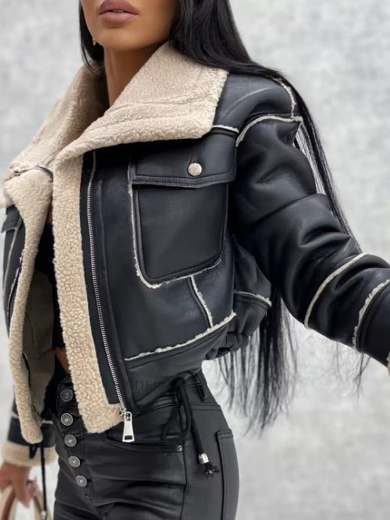 Black cropped sherpa trim jacket with zip front and chest pockets.