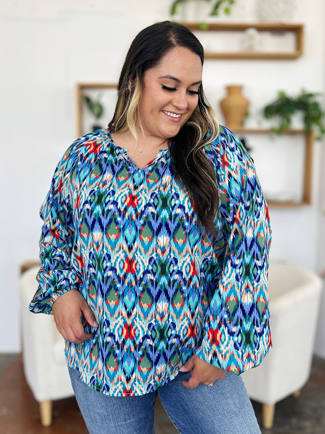 Prismatic ikat blouse with voluminous sleeves in blue and green, featuring a V-neck.