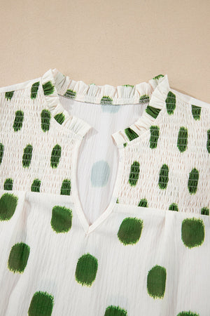 Textured polka dot blouse in matcha green with smocked yoke and v-neck.
