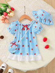 Baby dress set with blue gingham and strawberries, puff sleeves, red bow, and lace trim.
