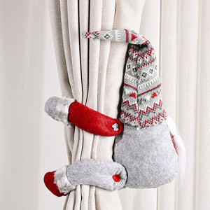 Charming gnome curtain tie-backs in red and gray with festive patterns.