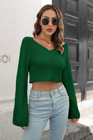 Dark green off-shoulder crop knit sweater with dramatic bell sleeves and a v-neck.