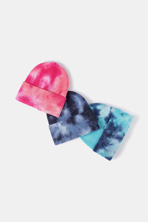 Ribbed knit beanies in pink/white, navy/white, and blue/white tie-dye patterns.