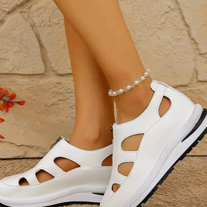 Chic white cutout wedge sneakers with zipper detail and chunky sole.