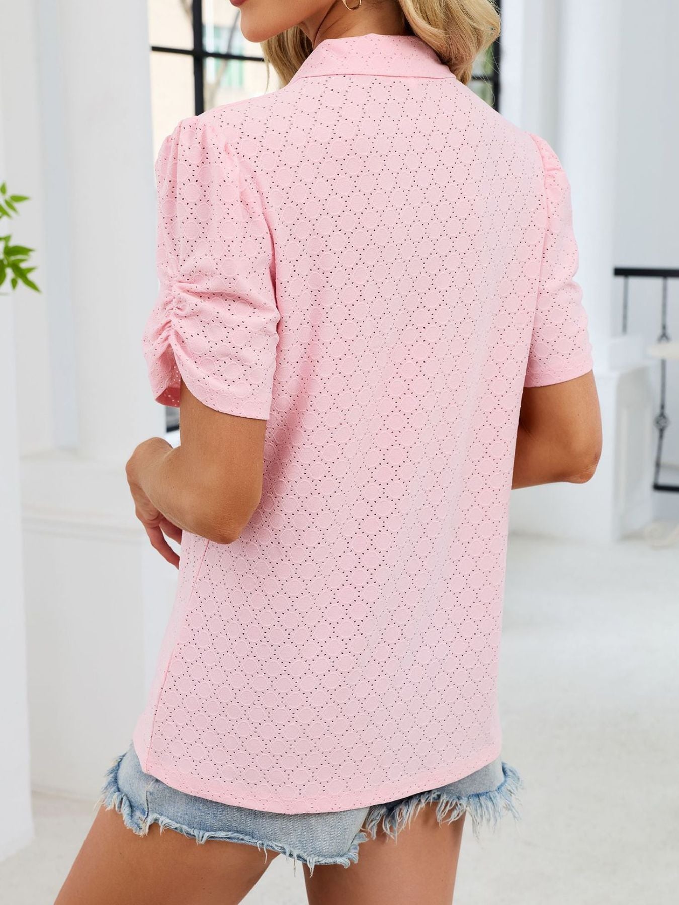 Pink eyelet ruched short sleeve blouse with a collared neckline.